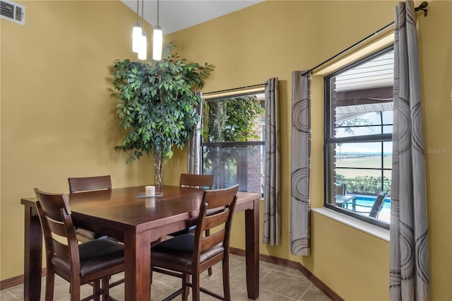 2825 Lake Tohopekaliga Blvd, Kissimmee, FL 34746 - dining room with baseboards, light tile patterned flooring, and visible vents