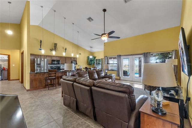 2825 Lake Tohopekaliga Blvd, Kissimmee, FL 34746 - living area with high vaulted ceiling, light tile patterned flooring, ceiling fan, french doors, and visible vents