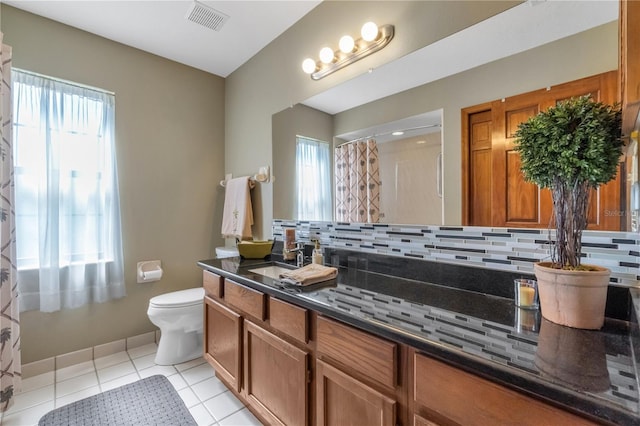 2825 Lake Tohopekaliga Blvd, Kissimmee, FL 34746 - bathroom with toilet, visible vents, backsplash, tile patterned flooring, and vanity
