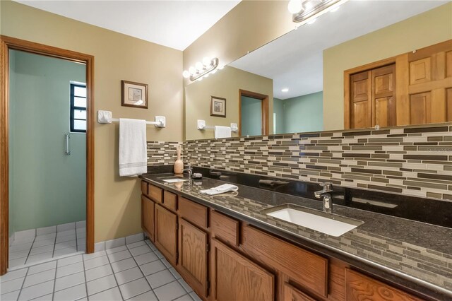 2825 Lake Tohopekaliga Blvd, Kissimmee, FL 34746 - full bathroom with tile patterned flooring, backsplash, double vanity, a sink, and baseboards