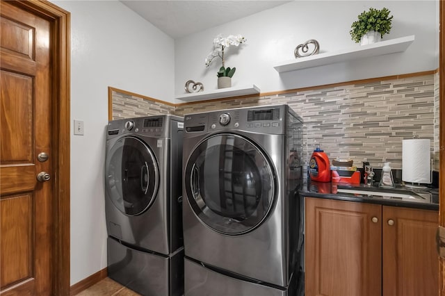 2825 Lake Tohopekaliga Blvd, Kissimmee, FL 34746 - laundry room featuring tile patterned floors, washer and dryer, and cabinet space