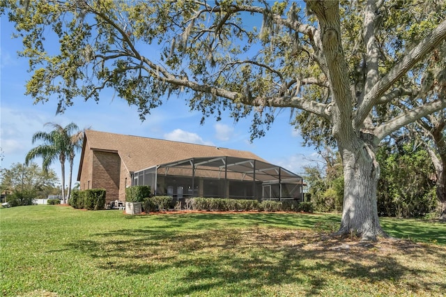 2825 Lake Tohopekaliga Blvd, Kissimmee, FL 34746 - rear view of property with a lanai and a yard