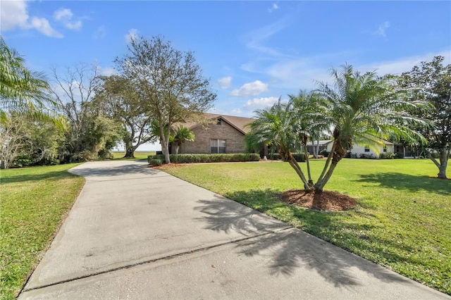 2825 Lake Tohopekaliga Blvd, Kissimmee, FL 34746 - obstructed view of property with a front yard and concrete driveway