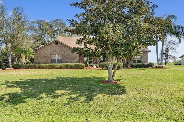 2825 Lake Tohopekaliga Blvd, Kissimmee, FL 34746 - obstructed view of property featuring brick siding and a front yard