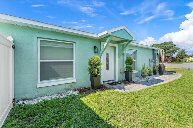 exterior space featuring a front yard and stucco siding