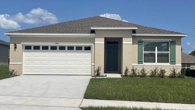 view of front of home featuring roof with shingles, stucco siding, an attached garage, driveway, and a front lawn