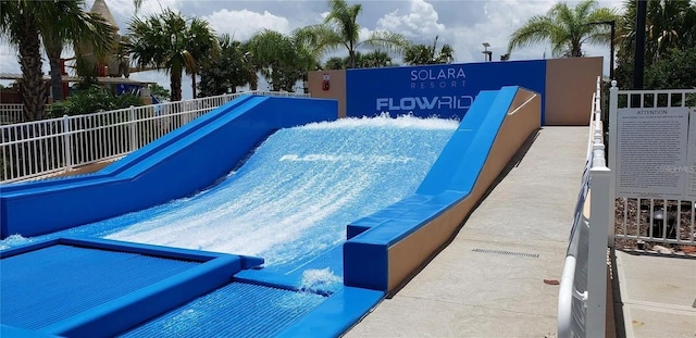 view of swimming pool with fence