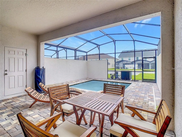 view of patio with glass enclosure and an outdoor pool