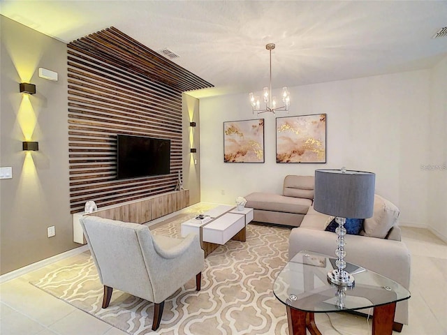 living room featuring visible vents, a notable chandelier, baseboards, and light tile patterned floors