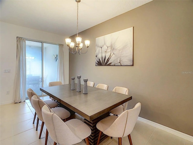 dining room featuring a notable chandelier, baseboards, and light tile patterned floors