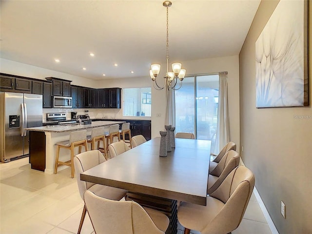 dining room with recessed lighting, a notable chandelier, baseboards, and light tile patterned floors