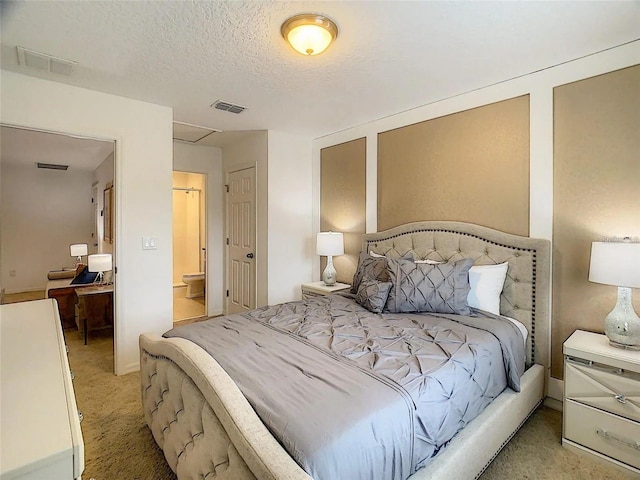 bedroom featuring light carpet, visible vents, a textured ceiling, and ensuite bathroom