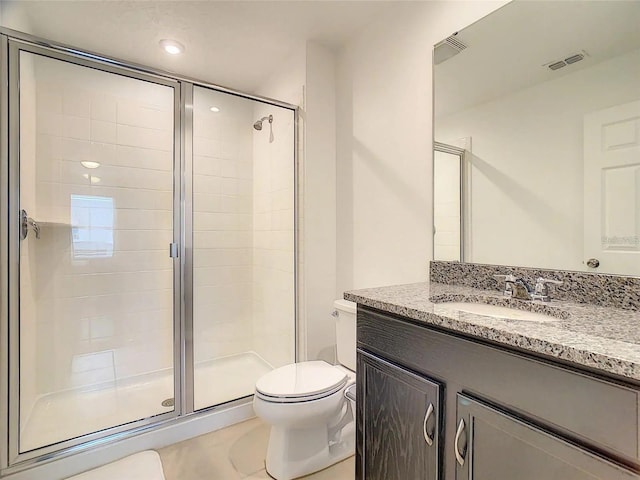 full bathroom featuring a stall shower, visible vents, vanity, and toilet