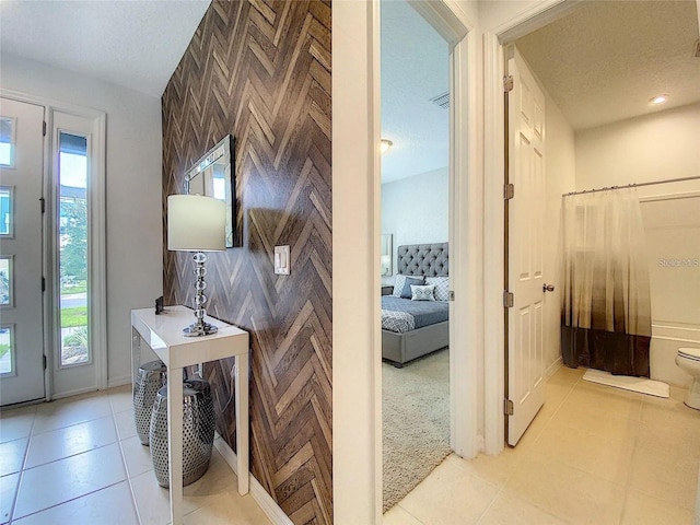 interior space featuring light tile patterned floors, visible vents, and a textured ceiling