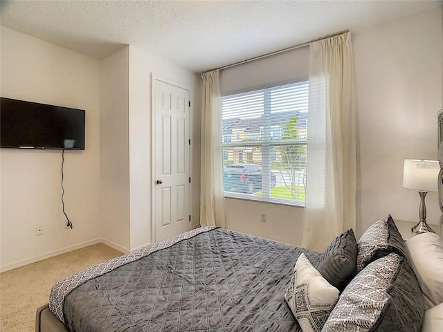 bedroom featuring baseboards and a textured ceiling