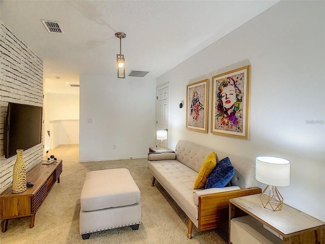 living area with light carpet, baseboards, and visible vents