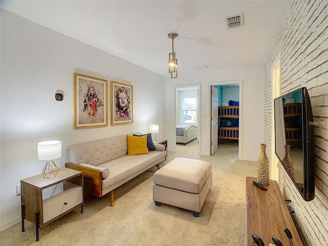 living area featuring light carpet, baseboards, and visible vents