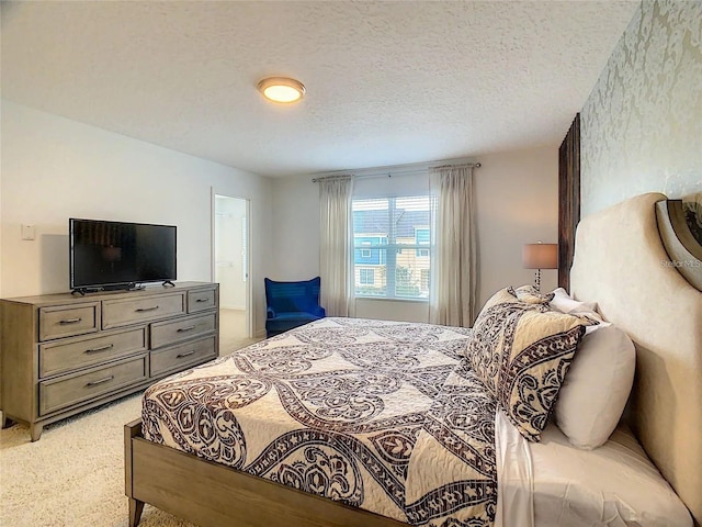 bedroom featuring a textured ceiling and light colored carpet