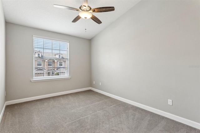 carpeted spare room with ceiling fan, baseboards, and a textured ceiling