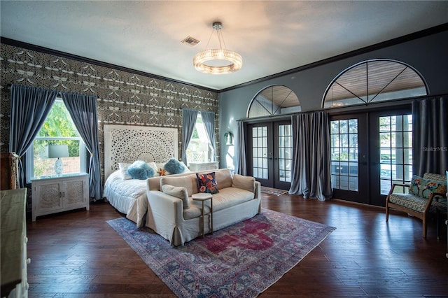 bedroom featuring dark wood-style floors, french doors, crown molding, visible vents, and access to outside