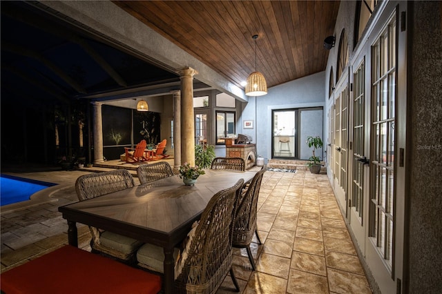 interior space with lofted ceiling, wood ceiling, and decorative columns