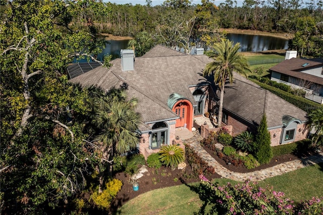 aerial view featuring a view of trees and a water view