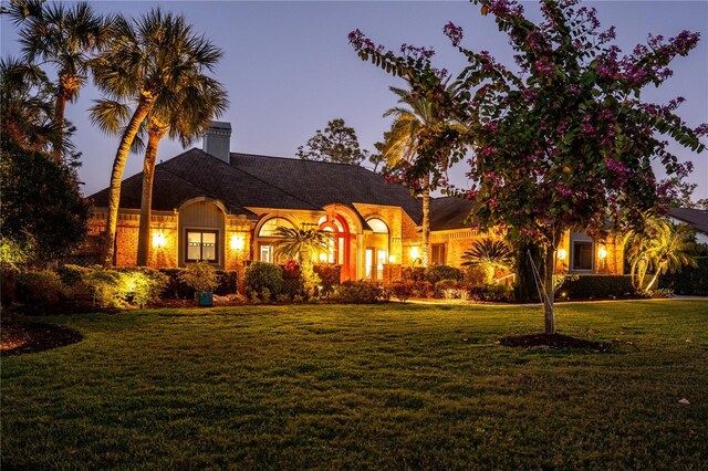 view of front of property featuring a chimney and a front yard