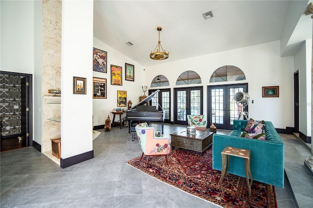 living area with high vaulted ceiling, tile patterned floors, french doors, baseboards, and visible vents