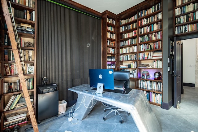 office area with bookshelves, baseboards, and tile patterned flooring
