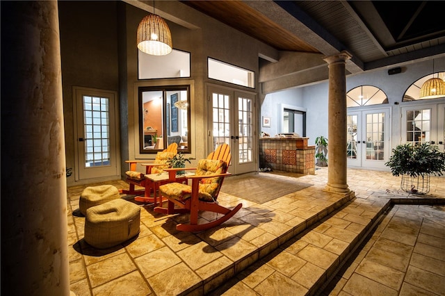 interior space with french doors and beam ceiling