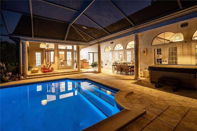 outdoor pool with a patio area, french doors, a hot tub, and outdoor dining space