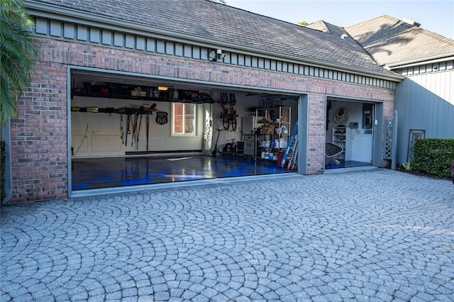 garage with decorative driveway