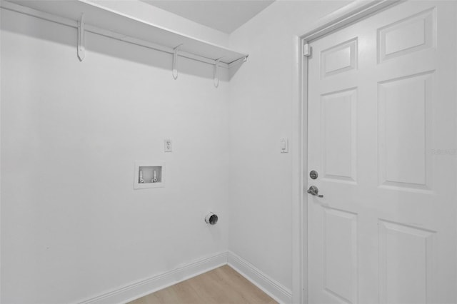 washroom featuring laundry area, baseboards, washer hookup, and light wood finished floors