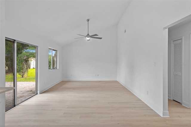 interior space featuring lofted ceiling, ceiling fan, light wood-style flooring, and baseboards