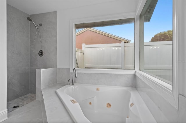 bathroom with a wealth of natural light, a whirlpool tub, and walk in shower