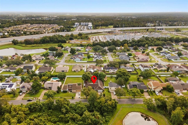 birds eye view of property featuring a residential view and a water view