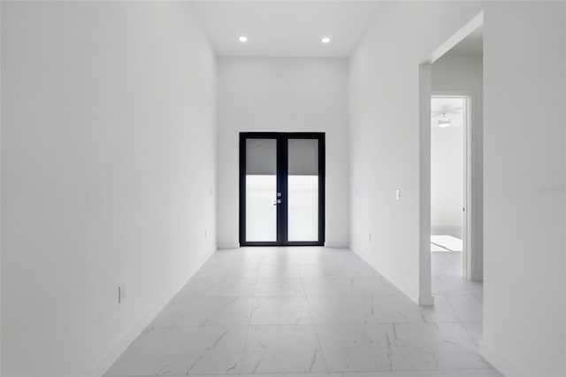 entryway featuring marble finish floor, french doors, recessed lighting, and baseboards