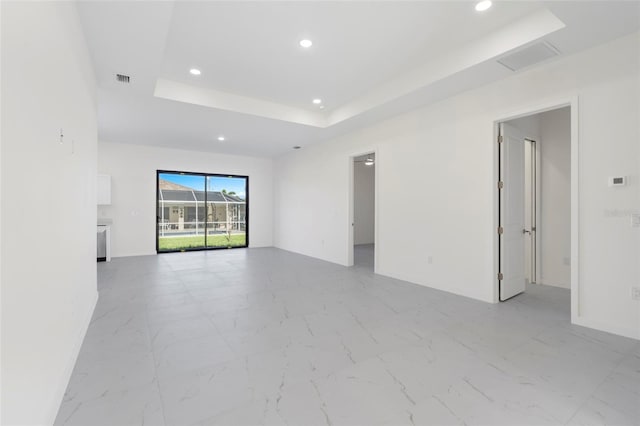 spare room featuring visible vents, baseboards, a raised ceiling, marble finish floor, and recessed lighting