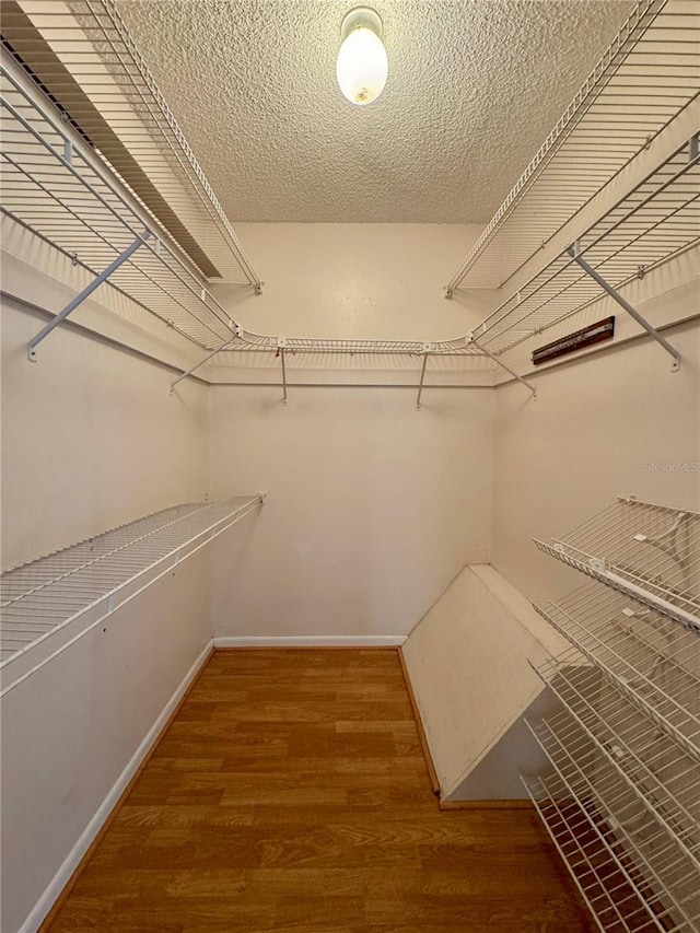 spacious closet with wood finished floors