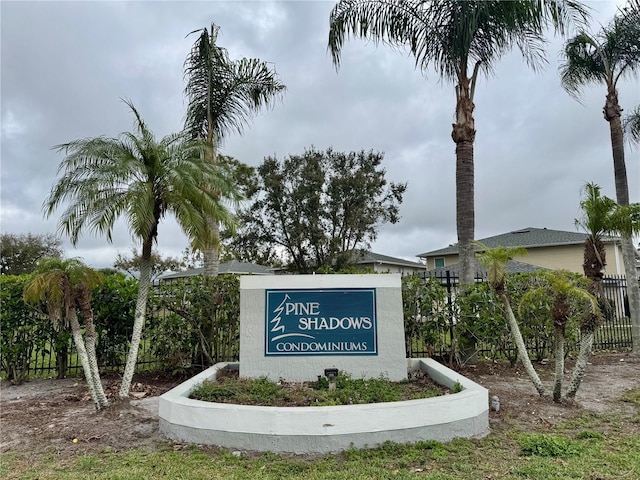 community / neighborhood sign with fence