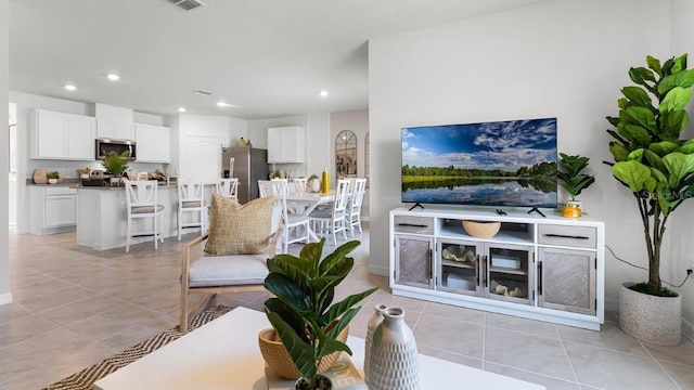 living room featuring light tile patterned floors and recessed lighting