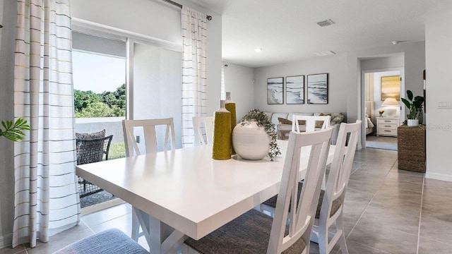 dining room featuring visible vents and light tile patterned floors