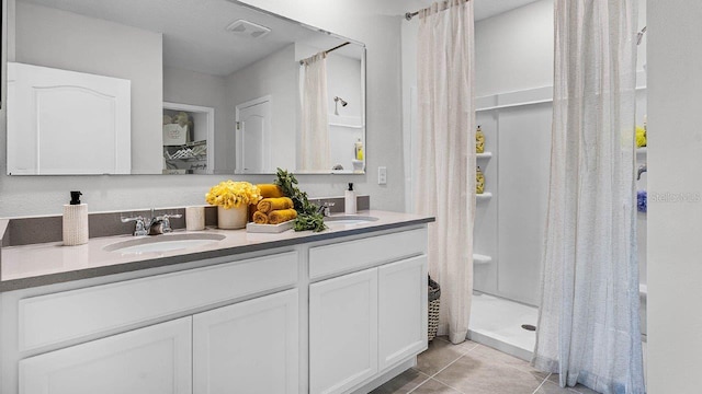 bathroom featuring a stall shower, visible vents, a sink, and tile patterned floors