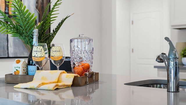 details featuring white cabinetry and a sink