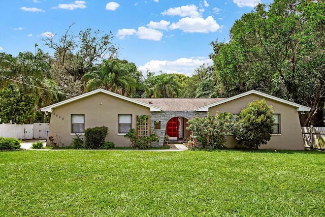 single story home with a front yard, fence, and stucco siding