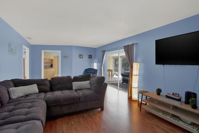 living room with wood finished floors and visible vents