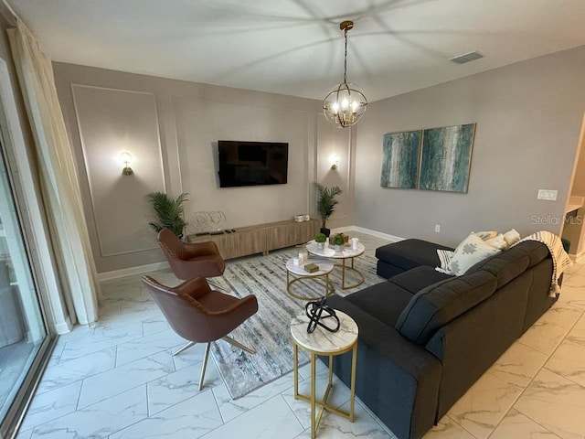 living room with baseboards, marble finish floor, visible vents, and an inviting chandelier