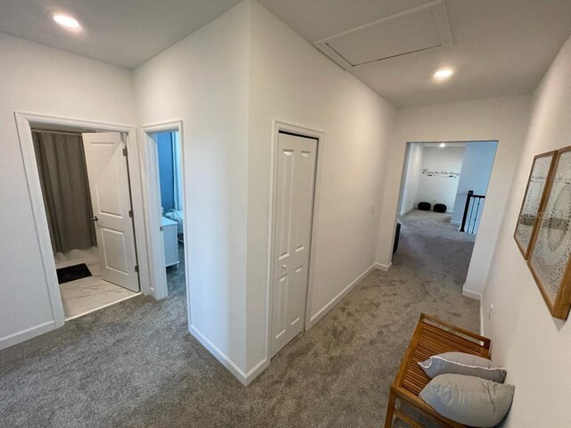 corridor with carpet, an upstairs landing, and baseboards