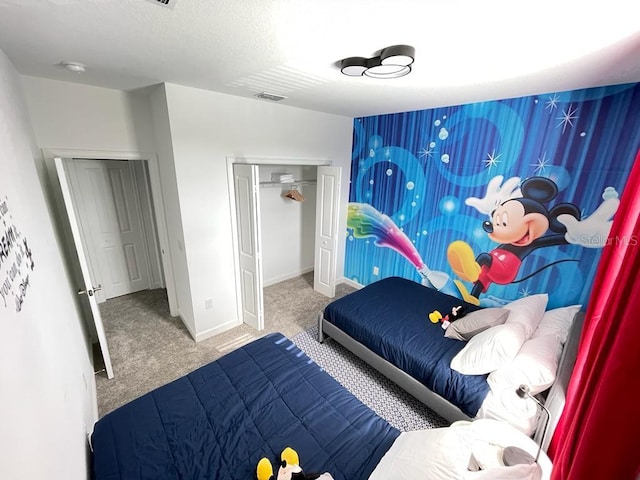 bedroom with carpet, a closet, a textured ceiling, and baseboards