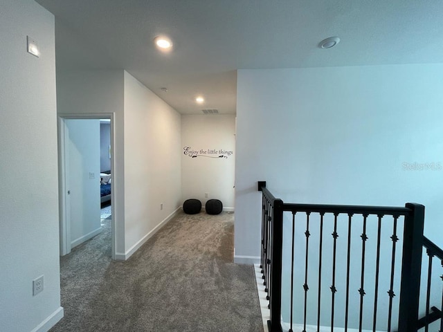 hallway featuring recessed lighting, visible vents, carpet flooring, an upstairs landing, and baseboards